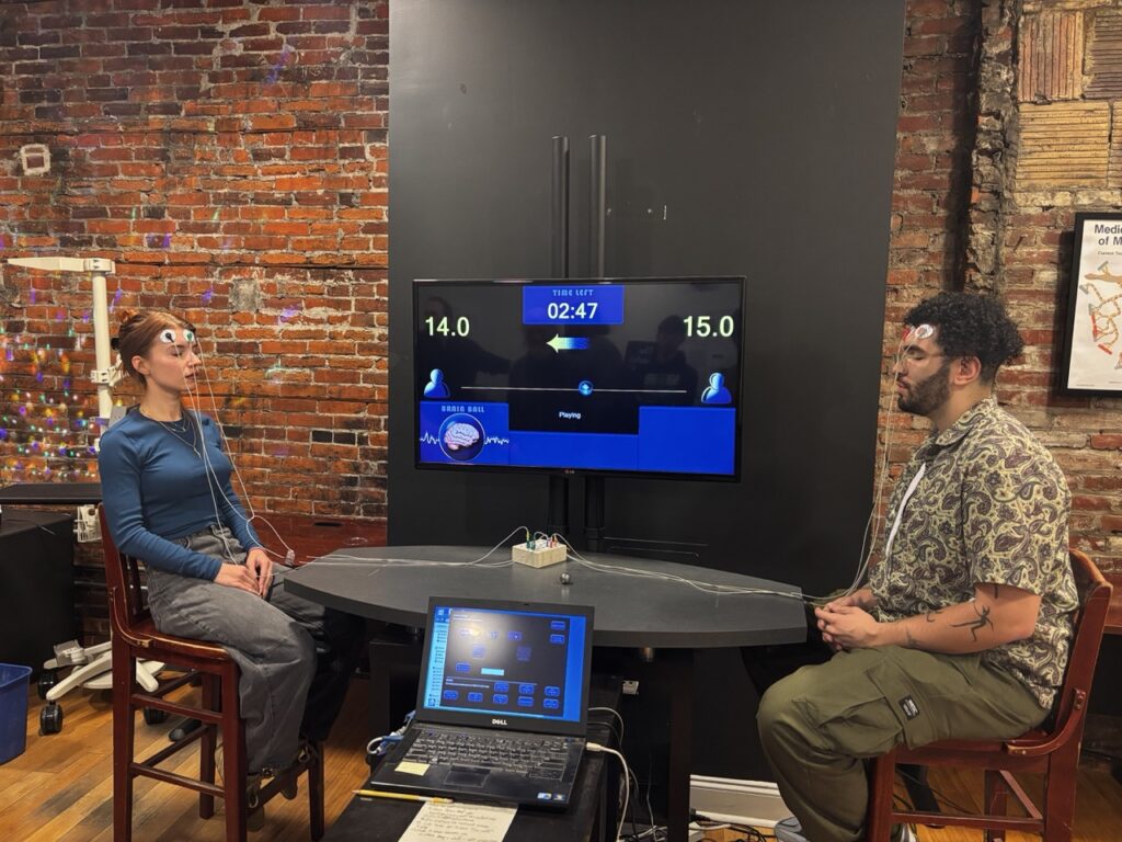 Blogs media: olivia biordi and luca catus playing brainball at the moberg holiday party